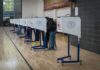 Texas Latino Surge Rattles The Red Wall Voters at polling booths in a gymnasium
