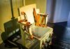Governor Orders Probe After Botched Execution Sparks Nationwide Firestorm Electric chair with leather restraints in a dim room