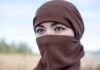 Taxpayers Unknowingly Funding Free Hijabs For Illegals Tatiana Akimova wearing a brown headscarf covering lower face outdoors
