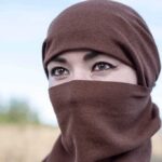 Taxpayers Unknowingly Funding Free Hijabs For Illegals Tatiana Akimova wearing a brown headscarf covering lower face outdoors