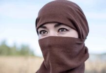 Taxpayers Unknowingly Funding Free Hijabs For Illegals Tatiana Akimova wearing a brown headscarf covering lower face outdoors