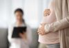Influencer ABORTING Baby Because He’s a boy! Pregnant woman holding belly during medical visit