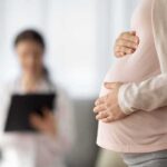 Influencer ABORTING Baby Because He’s a boy! Pregnant woman holding belly during medical visit