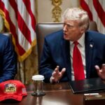 Donald Trump speaks at a meeting table beside Marco Rubio