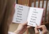 34 MISSING Kids Rescued in Three-Day Operation Hands holding a notebook with baby name lists near a crib