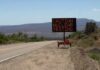 Electronic roadside sign warning of nuclear testing in desert