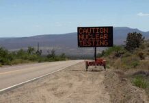 Electronic roadside sign warning of nuclear testing in desert