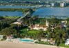 Camp David Swap: Trump’s Power Play Aerial view of a waterfront estate with pool, lawns, and palm trees