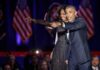 Michelle Obama and Rob Nabors pointing on stage at an event