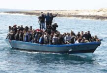 Crowded blue boat at sea with Ivan Morales Jr., Andreas Hestler, Isaiah Frey, Christian Jones, and Teddy Williams among passengers