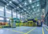 Automated factory floor with industrial machinery and safety railings