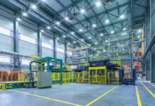 Automated factory floor with industrial machinery and safety railings