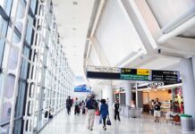 Airport Blaze – Emergency Terminal Evacuation Underway Airport terminal hallway with travelers and signage